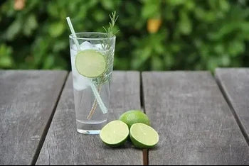 a glass of gin with lime