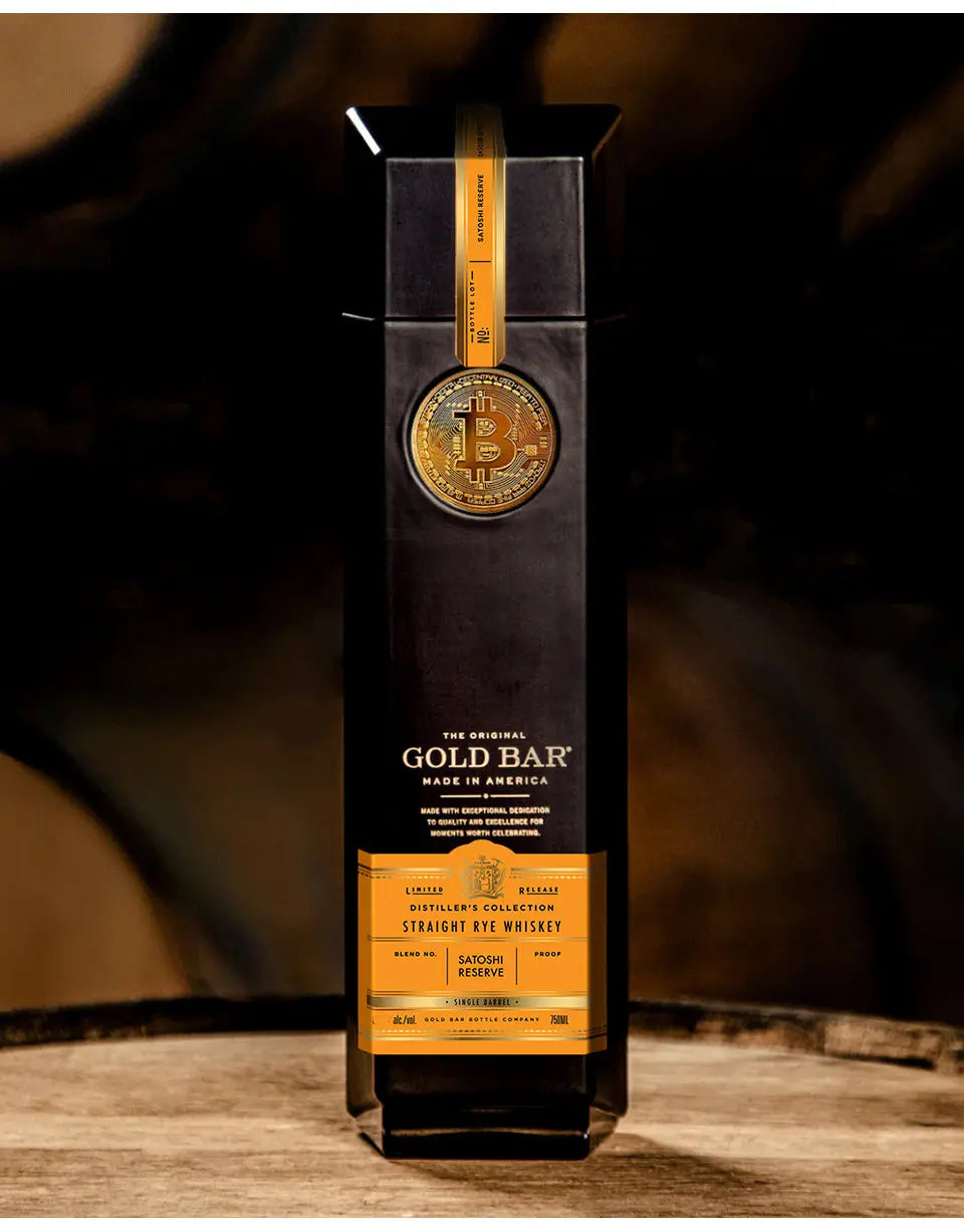 Bottle of The Gold Bar whiskey with a dark label and gold accents on a wooden surface.