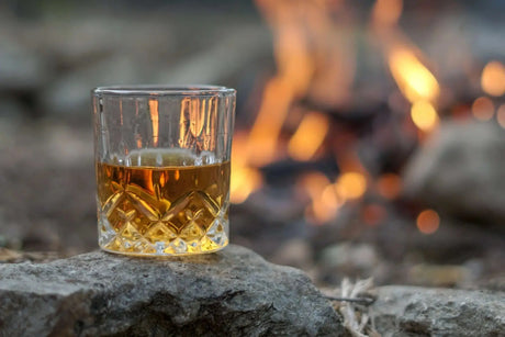 Bourbon glass beside responsible drinking information