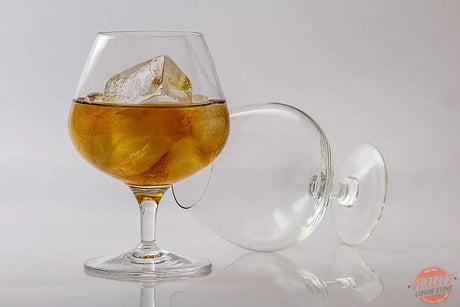 Brandy in a tulip glass with fruit and oak