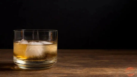 Boulevardier cocktail with orange peel beside whiskey