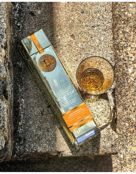 Gorilla Glue packaging with a glass of amber liquid on a textured surface