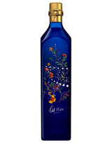 Blue bottle with floral design and gold cap on a white background